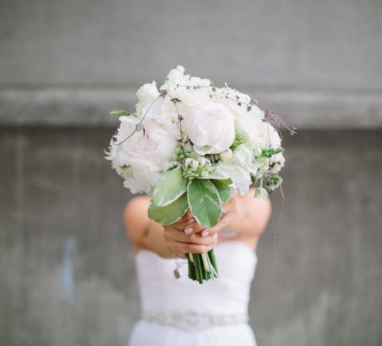 Close up of Rachel's bouquet held in front of her.